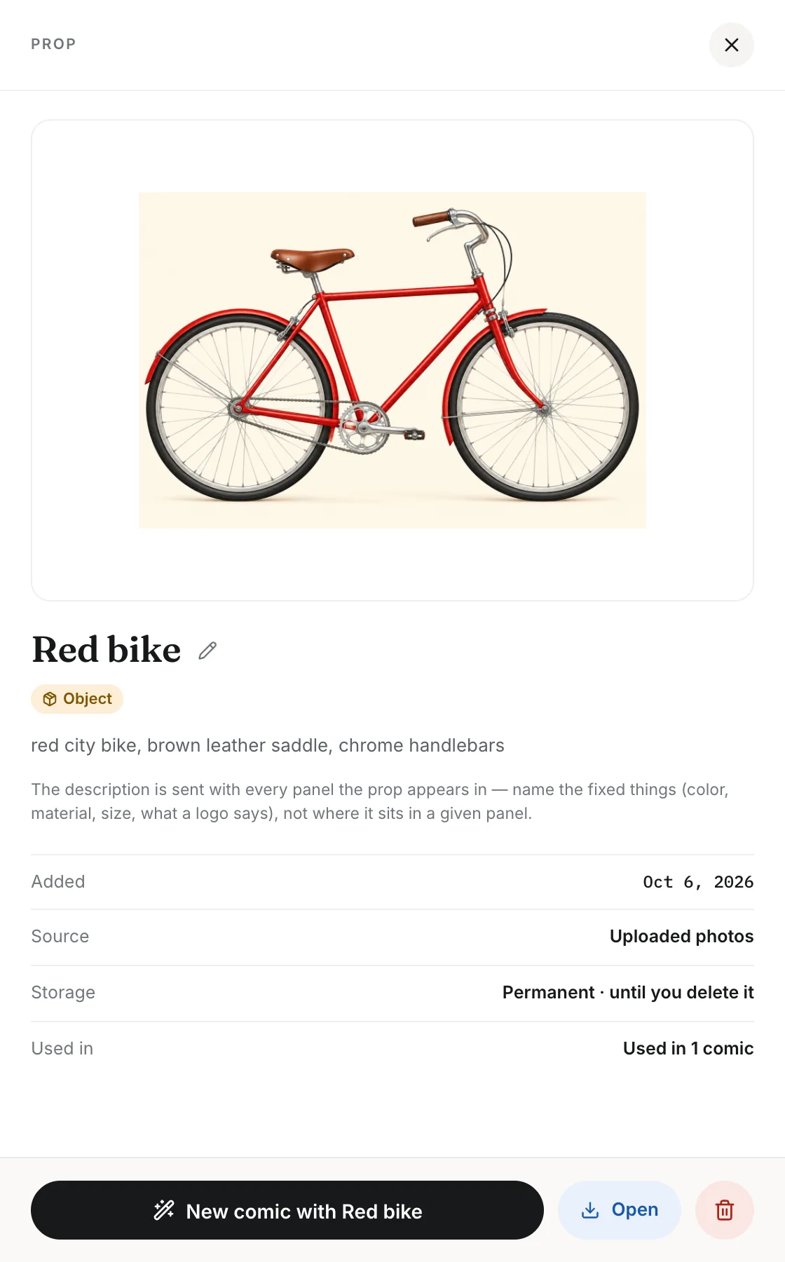 A prop's detail panel showing the red bike photo, its description and a New comic button